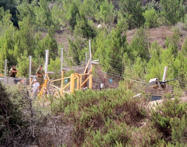 ورشة للعدو تعمل على صيانة السياج الحدودي الفاصل