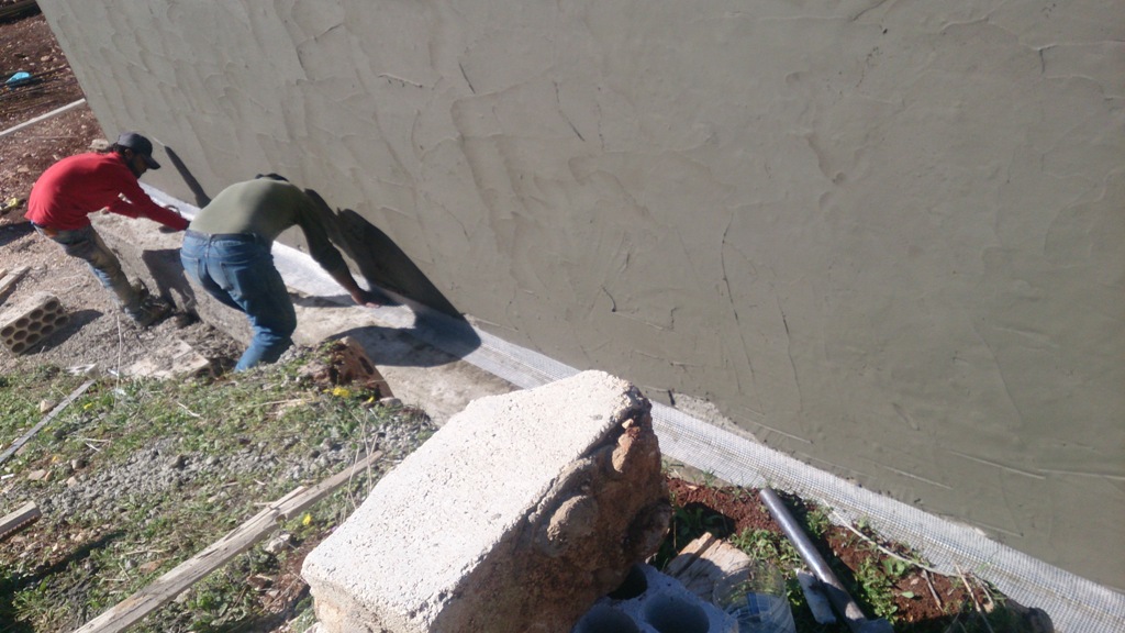 4- أعمال جدار الدعم وعزله (الطبقة السوداء هي مانع للنش والرطوبة فيما الطبقة ذات اللون الزهري هي لحماية مانع النش عند أعمال الردم خلف الجد