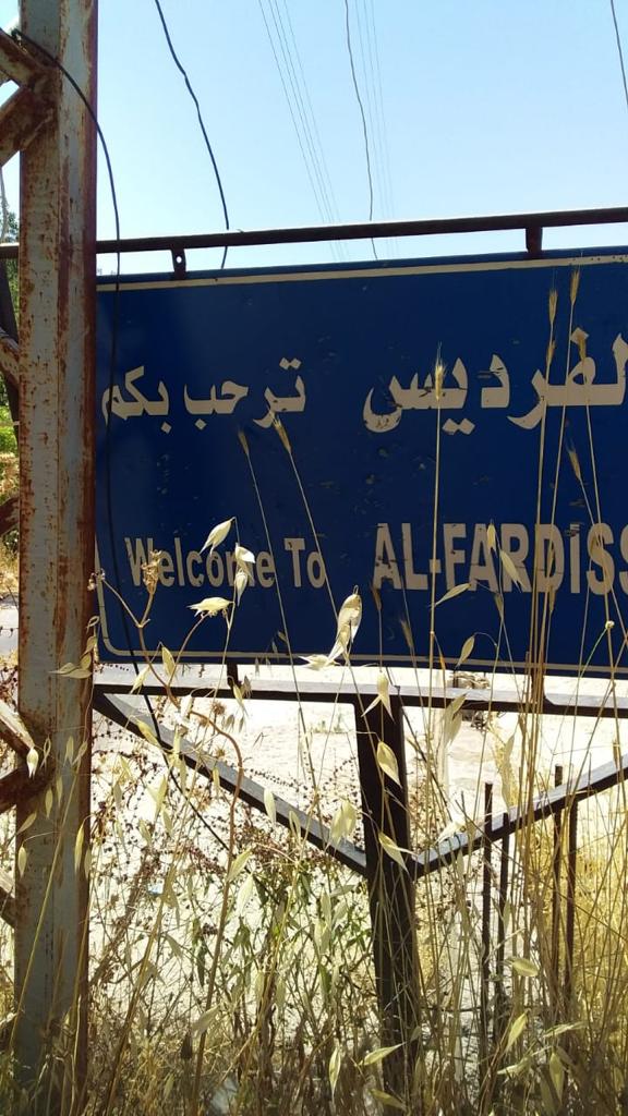 لوغو الفرديس يوضع على صورة البلدة